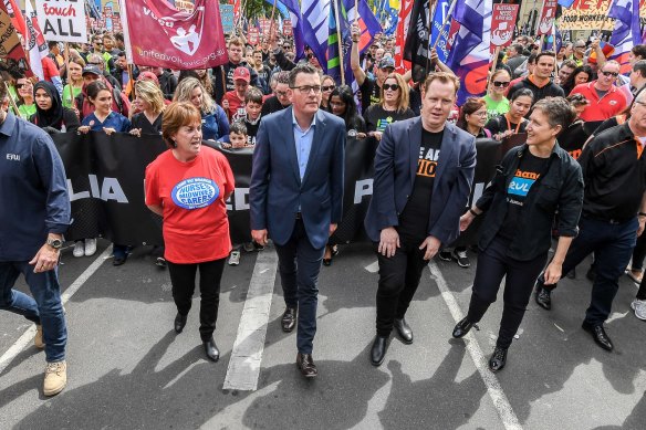 Luke Hilakari (second from right, front row) alongside Premier Daniel Andrews at a protest.