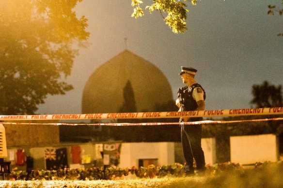 A policeman stands guard at al-Noor Mosque in Christchurch a week after the massacre.