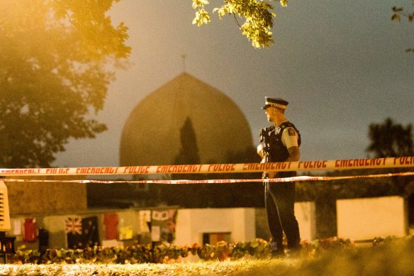 A policeman stands guard at al-Noor Mosque in Christchurch a week after the massacre in March 2019.