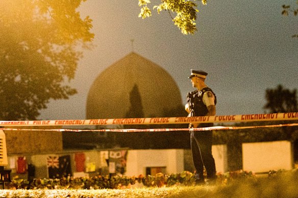 A policeman stands guard at al-Noor Mosque in Christchurch a week after the massacre in March 2019.