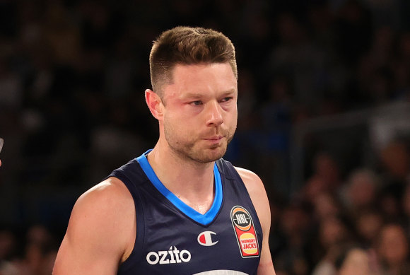 Matthew Dellavedova leaves the court after taking a blow to the head on Sunday.