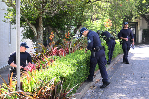 Police search garden beds near Baird’s home.