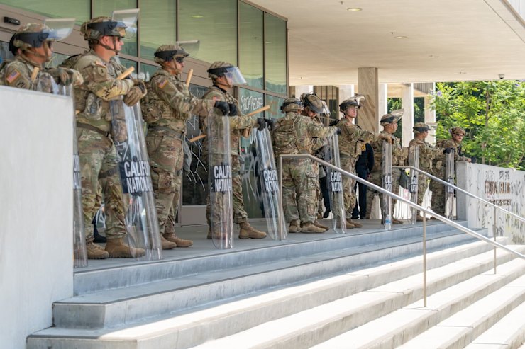 National⁣ Guard members stand outside the edward R. Roybal Federal Building ⁣in Los Angeles.