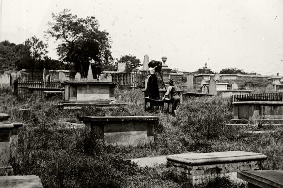 The Fosters take photographs at the former Devonshire Street Cemetery. 