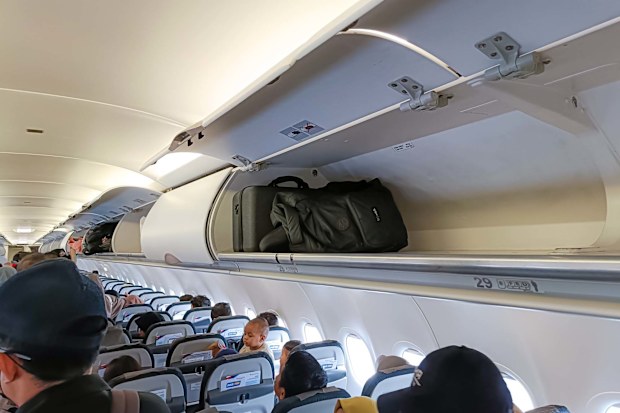 Carry-on baggage on the overhead bin of the aircraft cabin