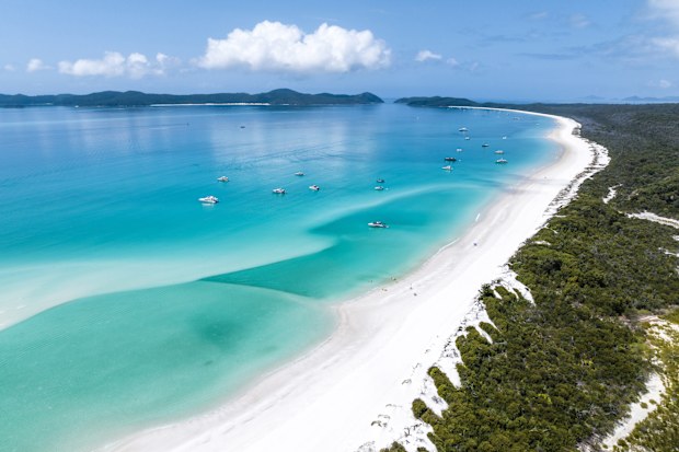 Beautiful high angle aerial drone view of famous Whitehaven Beach, part of the Whitsunday Islands National Park near the Great Barrier Reef, Queensland, Australia. Popular tourist destination.