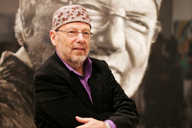 SYDNEY, AUSTRALIA - MARCH 17: Glenn A Baker stands in front of his portrait by Nafisa which was announced as the winner of the Packing Room Prize, winning AUD1,000 cash, at the Art Gallery Of NSW on March 17, 2010 in Sydney, Australia. First awarded in 1991, the Packing Room Prize is judged by the Gallery�s storeman, Steve Peters, as the shortlists for the annual art prize winners is announced. (Photo by Robert Gray/Getty Images)