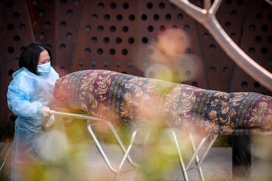 A body is taken from the Epping Gardens Aged Care facility during the outbreak. 