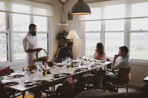 Friends enjoying food and drink in the dining room.
