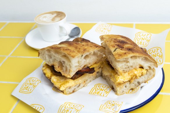 Cut Lunch Deli. Bacon, egg and cheese focaccia with chilli oil mayo. Randwick, August 23, 2022. Photo: Rhett Wyman/SMH .