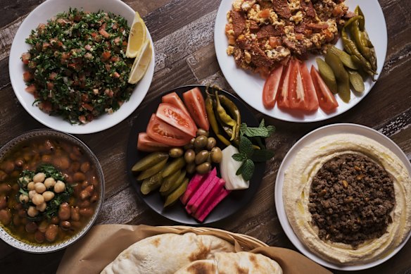 Eggs, sujuk, hummus, tabouli and pickles.