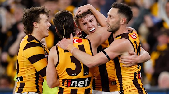 Calsher Dear of the Hawks celebrates a goal with teammates.