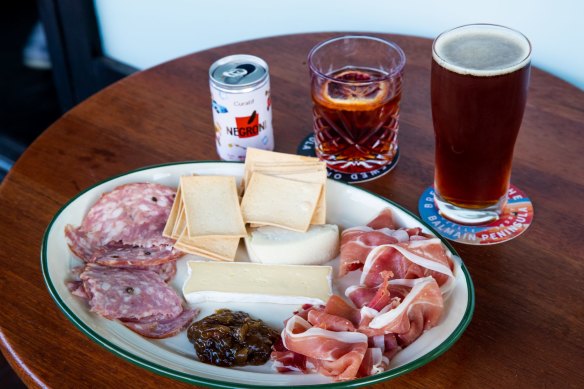 Negroni in a can, beer and a tasting cheese and meat plate. 