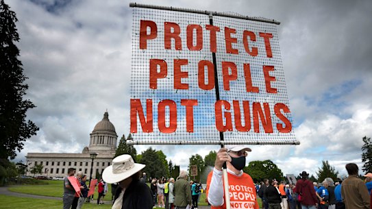 A protester stands with other gun-control advocates during a rally at the state Capitol in Olympia, Washington over the weekend. 