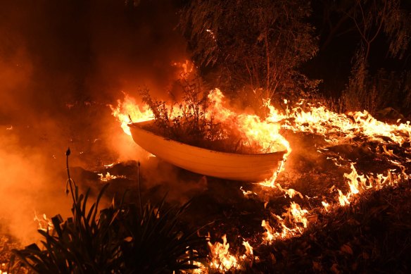 A small rowboat burns on the water at Failford during the Hillsville fire.