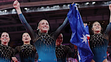 Emily Whitehead holds the flag in front of her teammates.