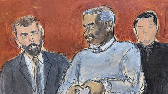 Sean Diddy Combs, center, motions a heart sign to his family in attendance as he is escorted out of lock-up by US Marshals, on the first day of trial, Monday, May 12, 2025, in New York.