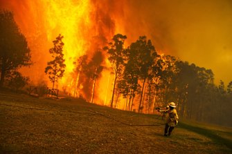 Wreck Bay fire crew protect a property from the Currowan fire. 