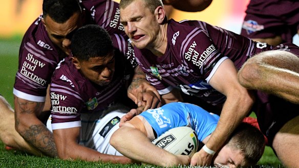 Taking a toll: Manly lost 34-42 to the Titans with a shroud hanging over the side.
