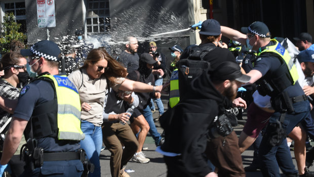 Police use capsicum spray on protesters on Saturday.