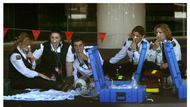 Melbourne Airport staff breathing with oxygen masks.