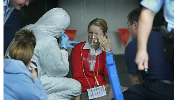 People being treated by emergency  crews outside the airport terminal