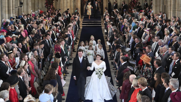 The star-studded congregation watch the pair walk down the aisle after they were married in St George’s Chapel.