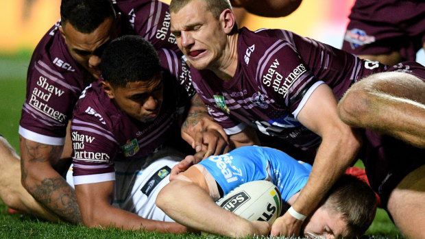 Taking a toll: Manly lost 34-42 to the Titans with a shroud hanging over the side.