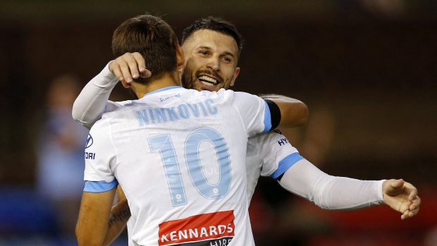  Kosta Barbarouses celebrates with the architect of his goal, Milos Ninkovic.