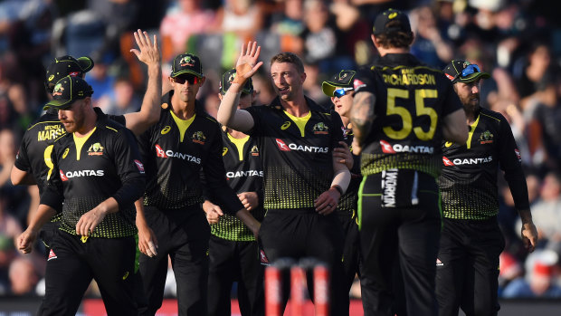Daniel Sams is congratulated by Australian teammates after dismissing Kiwi superstar Kane Williamson in February.