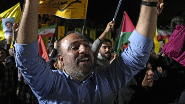 Demo<em></em>nstrators cheer as they wave Iranian and other flags in an anti-Israeli gathering celebrating Iran’s missile strike against Israel at Felestin (Palestine) Sqare in Tehran.