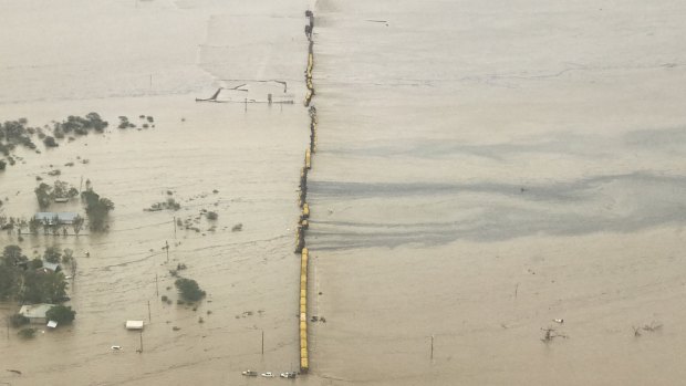 The aerial view of the train with wagons flipped over and what appeared to be a chemical slick.