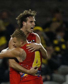 Ben King and former Tiger Brandon Ellis embrace after a goal during Gold Coast’s stunning win over Richmond.