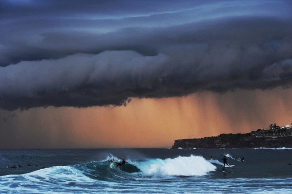 Surfers ride big waves along the Sydney coastline in November 2015.