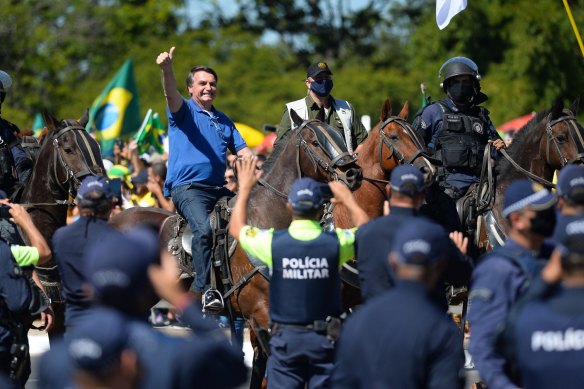 Jair Bolsonaro rides a horse during a rally in support of his presidency amid the coronavirus pandemic.