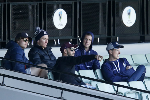 Will Pucovski (back left) and Glenn Maxwell (centre) support their Victorian teammates at the MCG on Sunday. 