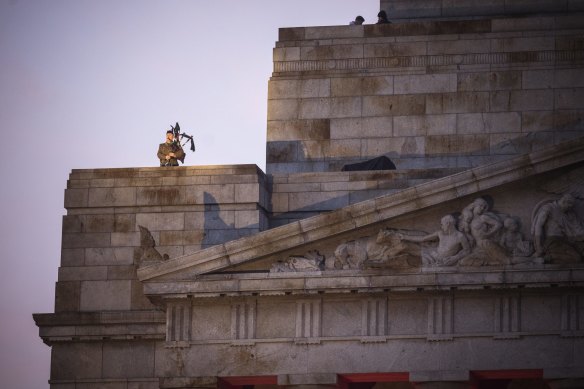 A lone piper plays at the ANZAC Day Dawn Service.