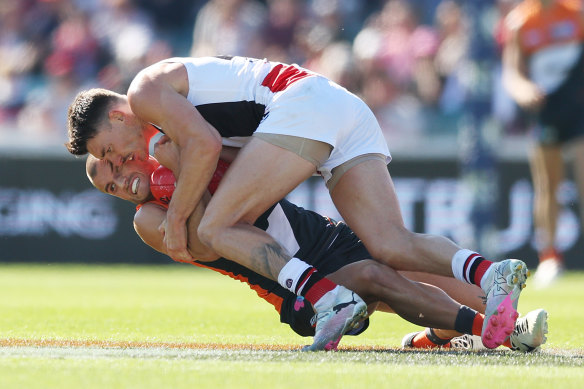 Xavier O’Halloran of the Giants is tackled by Josh Battle of the Saints.