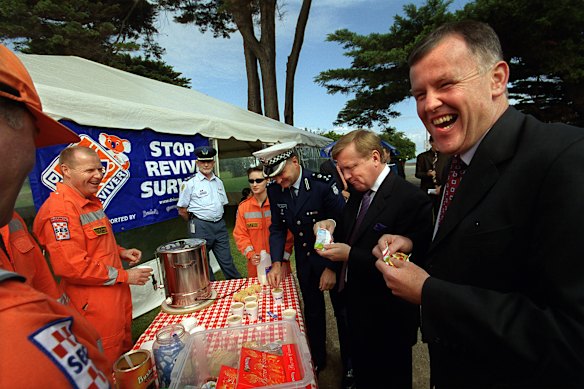 SES volunteer Wayne Barnes serves snacks and coffee to the then Victorian police commander Bob Hastings and then-government MPs Andre Haermeyer and Rob Hulls at a past launch of the Easter road safety campaign.