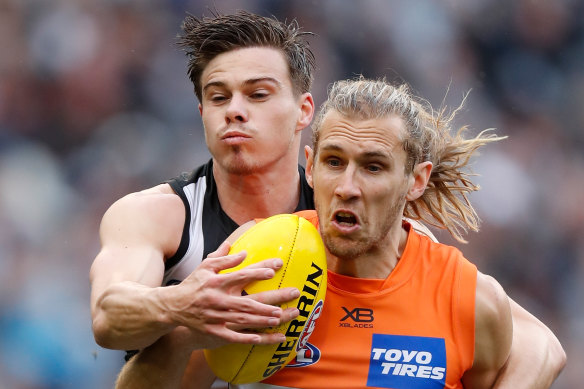 Magpie Josh Thomas (left) was awarded a goal that wasn't in Saturday's frantic final term. 