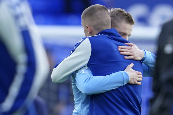 Ukrainians Oleksandr Zinchenko, of Manchester City, and Vitaliy Mykolenko, of Everton, embrace before the start of their Premier League fixture at Goodison Park.