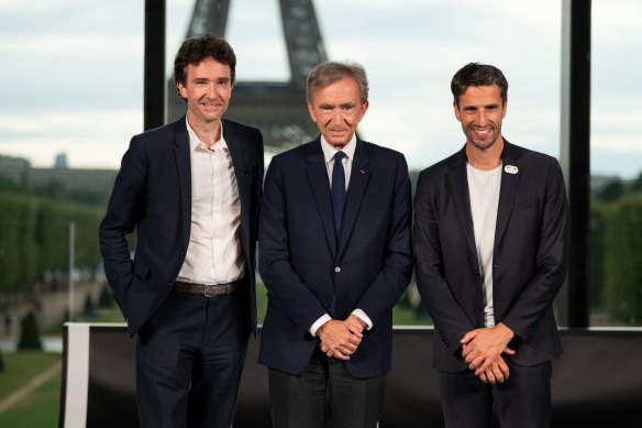 Antoine Arnault, vice chairman of Christian Dior (left), Bernard Arnault , chairman of LVMH (centre), and Tony Estanguet, president of the Paris 2024 Olympic and Paralympic Games.