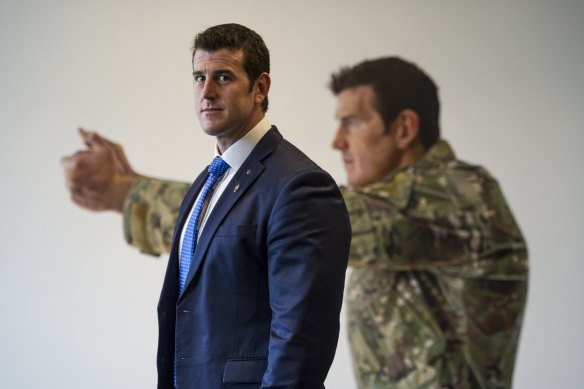 Ben Roberts-Smith in front of his portrait at the Australian War Memorial in 2014, painted by Michael Zavros.