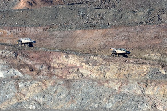 Haul trucks transport ore at the “super pit” near Kalgoorlie which is a large open-cut mine owned by Northern Star.