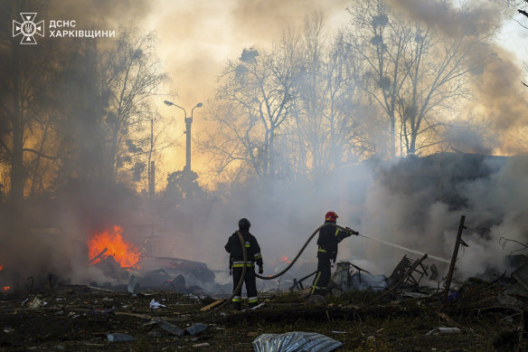 Ukrainian firefighters work in Kharkiv following a Russian rocket attack on Friday. Russia has unleashed a furious bombardment at critical Ukrainian infrastructure, after the US decided to withhold intelligence assistance. 