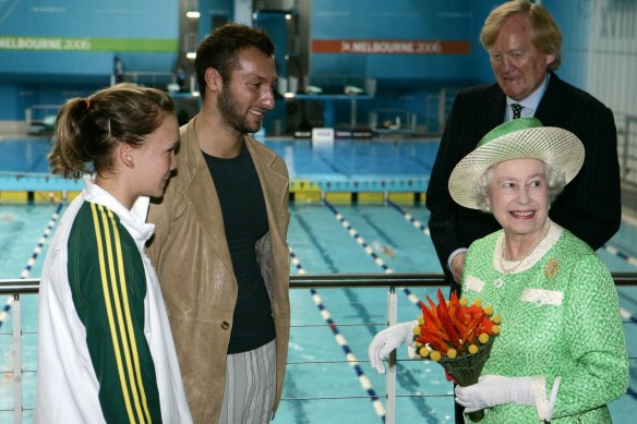 The late Queen Elizabeth II chats with Australian swimmers Kylie Palmer and Ian Thorpe and the late 2006 Games chief Ron Walker in Melbourne.