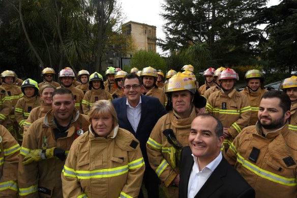 Voluntary and paid CFA members with Premier Daniel Andrews and then-Emergency Services Minister James Merlino in 2016 after cabinet endorsed the controversial fire services reform package. 