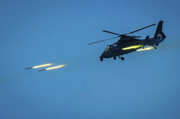 A Chinese armed helicopter fires rocket projectiles in a live-fire exercise off China's south-east coast. 