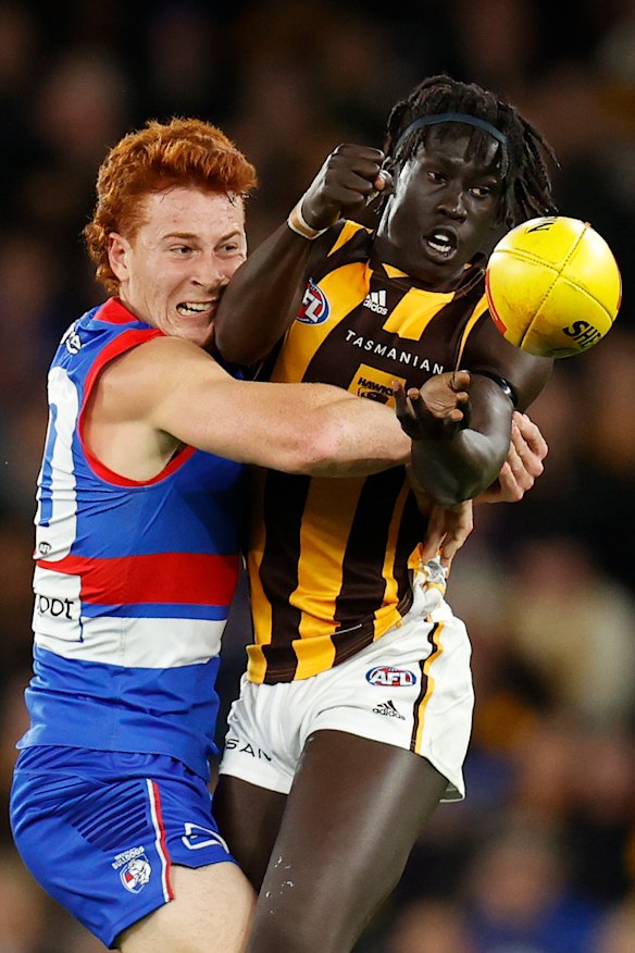 Changkuoth Jiath, right,  is tackled by Ed Richards.