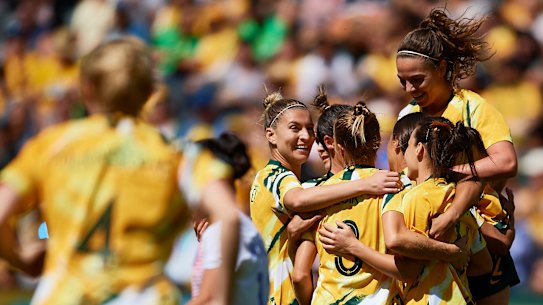 Prolific: The Matildas gather around Sam Kerr after she struck against Chile.